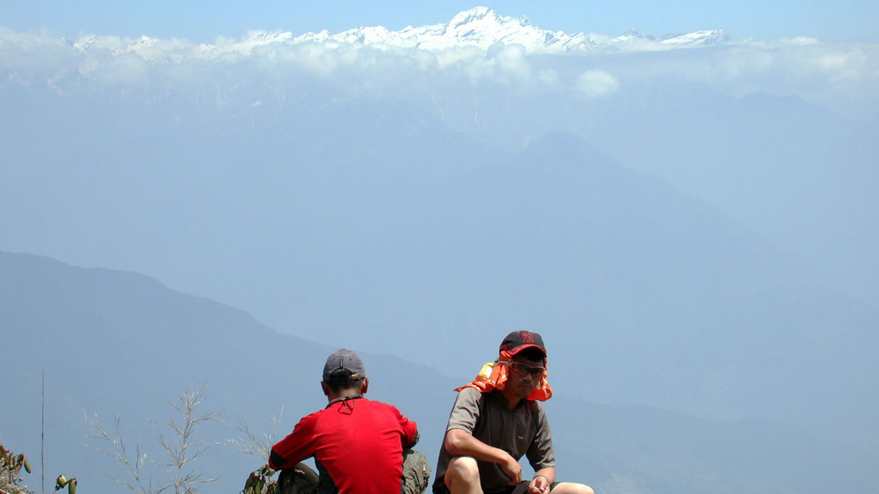 After the excursion was canceled, the guides sat back-to-back with Kanchenjunga in the background