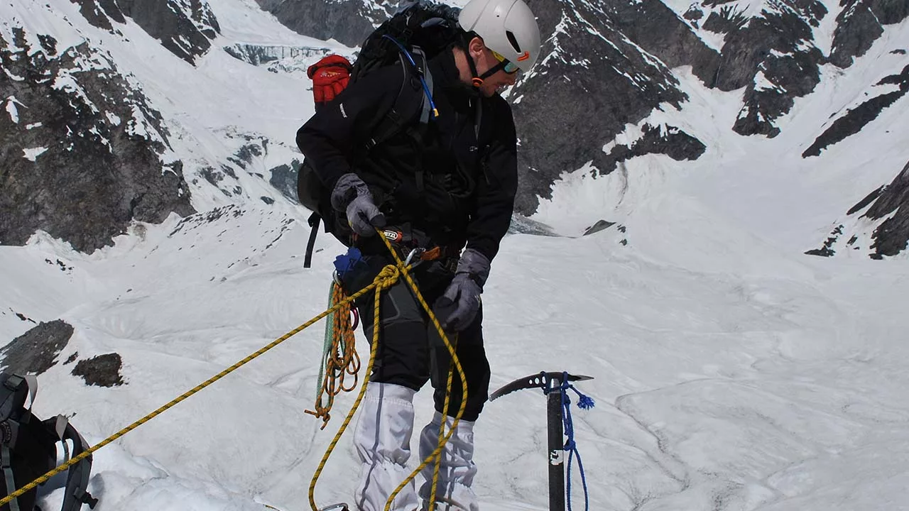 Climber belaying during glacier travel 