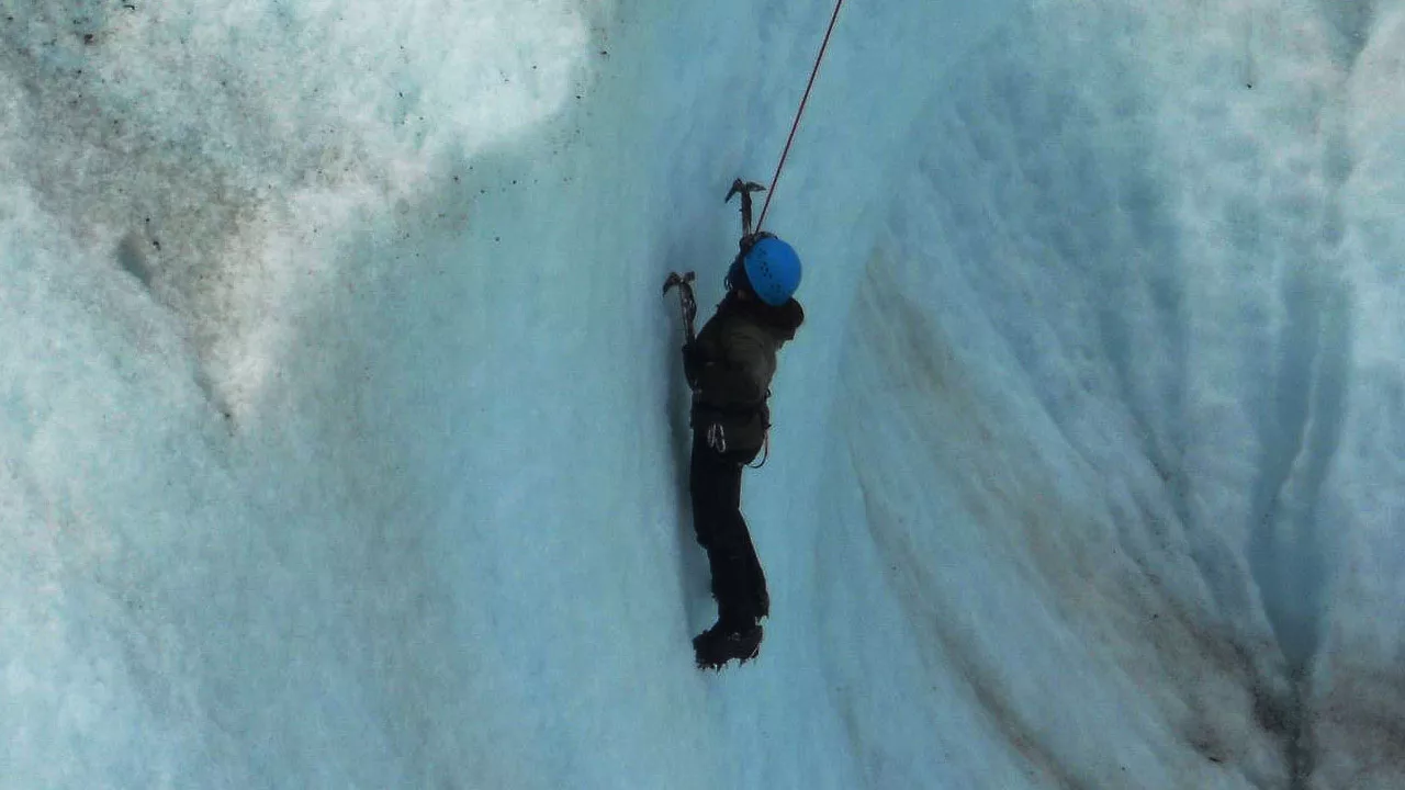 Climber on a crevasse ice wall 