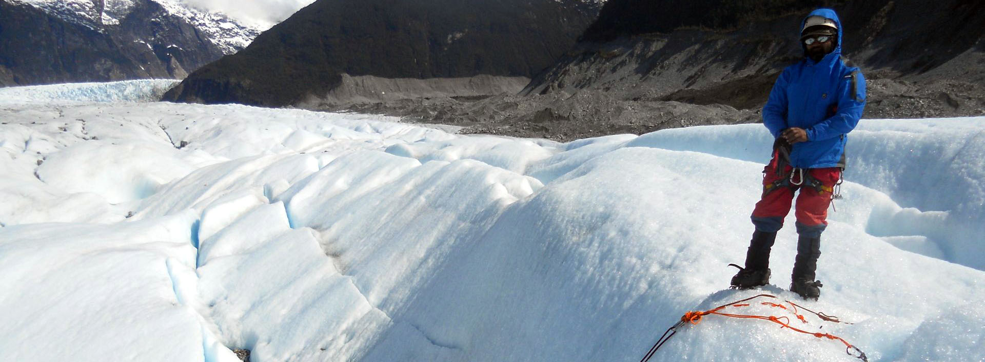 Pankaj Lagwal stands near an ice piton anchor for crevasse rescue trainees on Glacier Crevasses