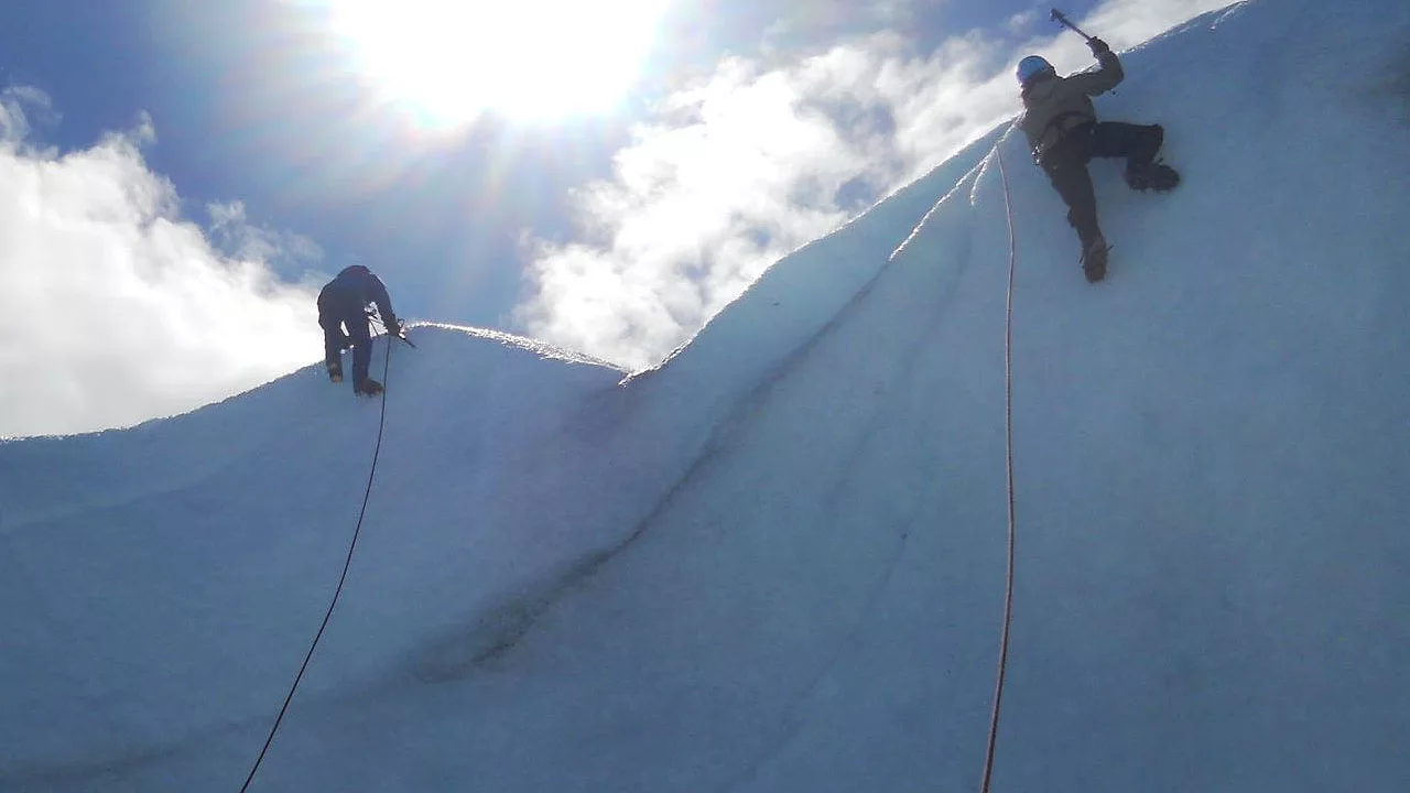 two climber climbing on ice wall 