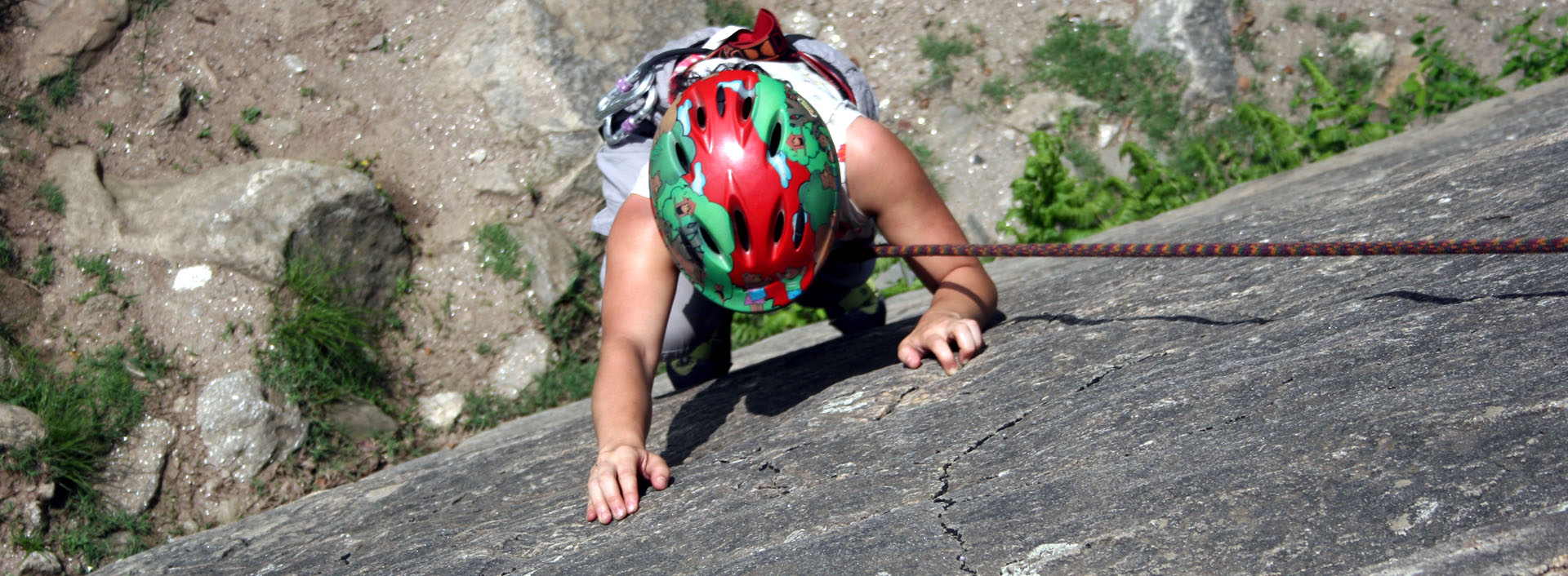 During a rock climbing course, a participant climbs with friction holds.
