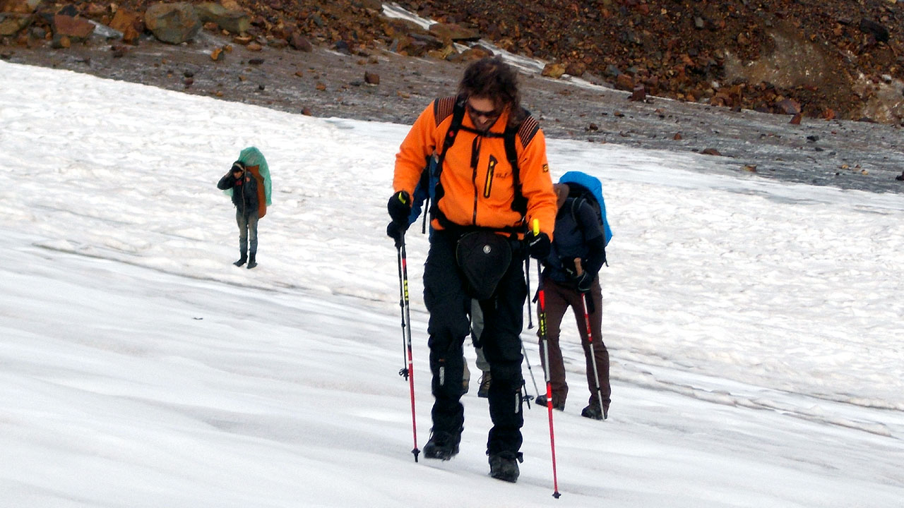 snow climbing skills course in the Indian Himalayas, a student learns to walk with walking sticks on a snowy area