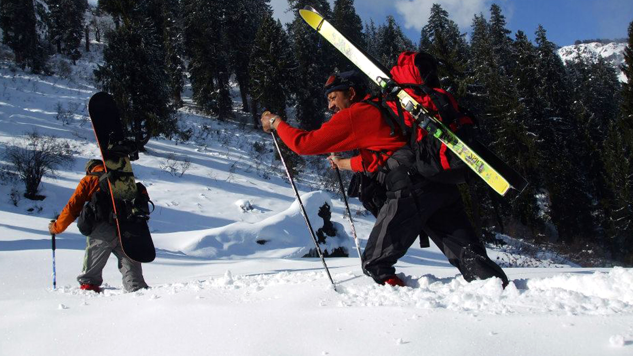 Surender Mahant climbing a snow mountain ridge in the Alpine Ski Mountaineering course
