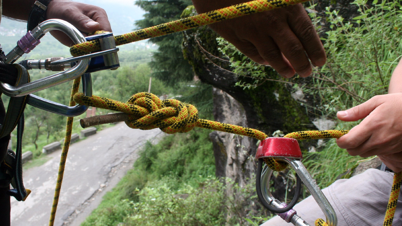 Climbers and belayers use rope attachments mountain training Himalayas 