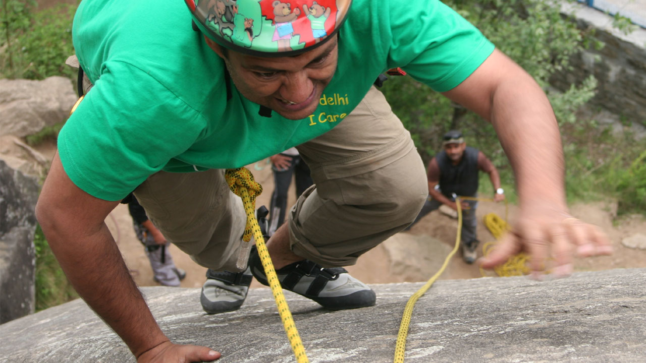 The trainee employs strength to complete the rock climbing pitch