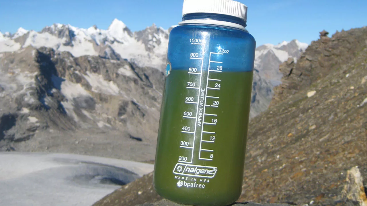 Nalgene water bottle with a view of the Pirpanjal mountain range in the background