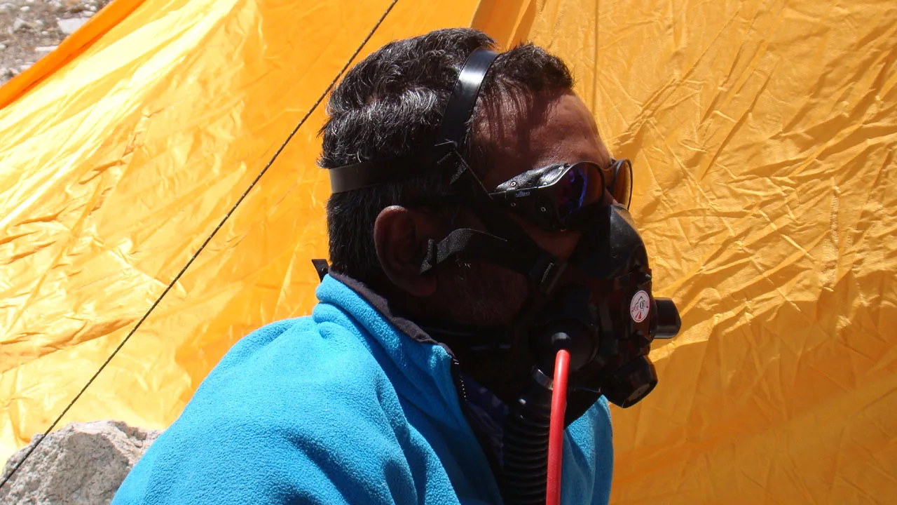 An instructor demonstrates how to use an oxygen mask when mountain climbing
