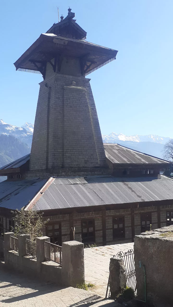 Manu Temple at Manali, Himachal Pradesh, with the greater Himalayas covered in snow in the background