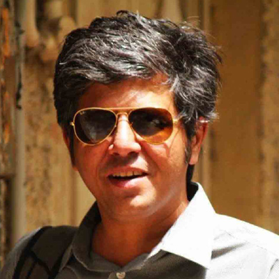 Neeraj Bhasin poses for a photograph while wearing Rayban sunglasses