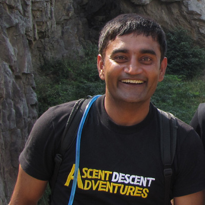 Pankaj Lagwal, wearing an Ascent Descent Adventures brand tshirt smiles