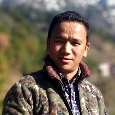 Passang Sherpa ADA mountain guide dressed in camouflage jacket and blue white check shirt