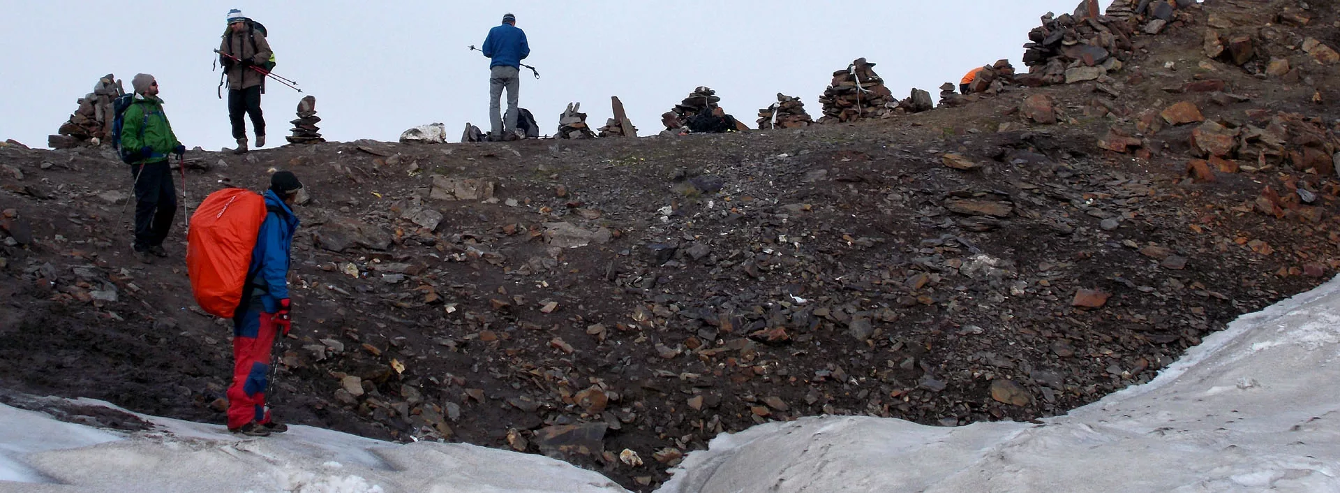 3 clients with Pankaj Lagwal on Pin Parvati Pass, which is marked with cairns
