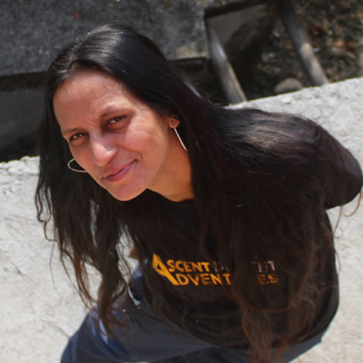 Shashi Tomar Lagwal smiles as she poses for a photograph while wearing an Ascent Descent Adventures tee