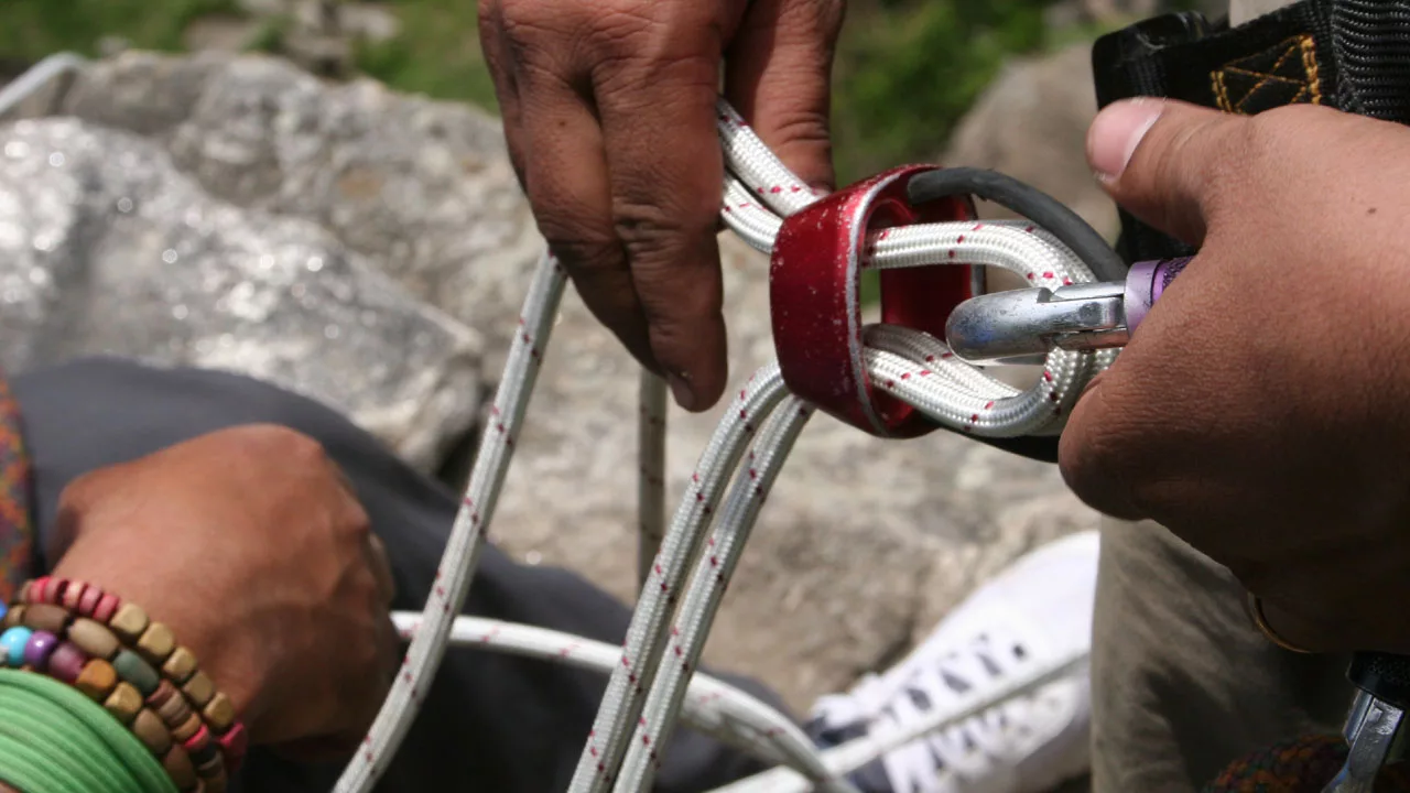 attaching rope with ATC on a carabiner for rappelling 