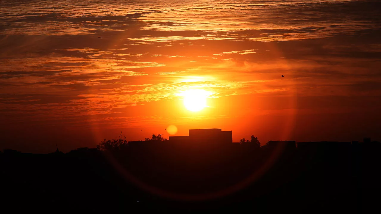 The sun sets against a crimson sky with cirrus clouds showing heat. El Nino Explanation