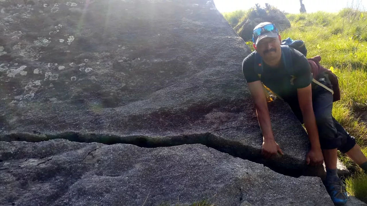 Surender Mahant flaunts his muscles in this photo while clutching a crack in a rock.