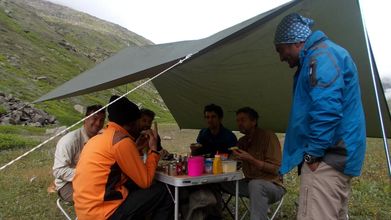 Group enjoying lunch under tarp during a hike