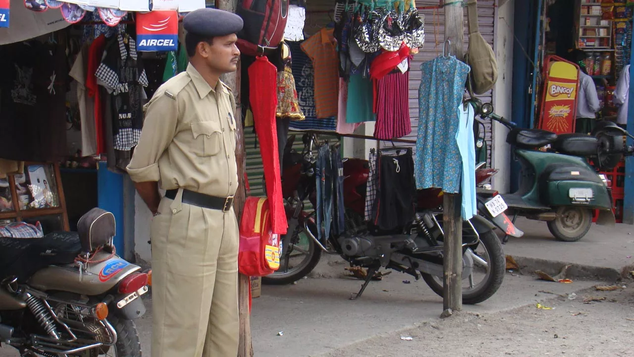cop standing in city market