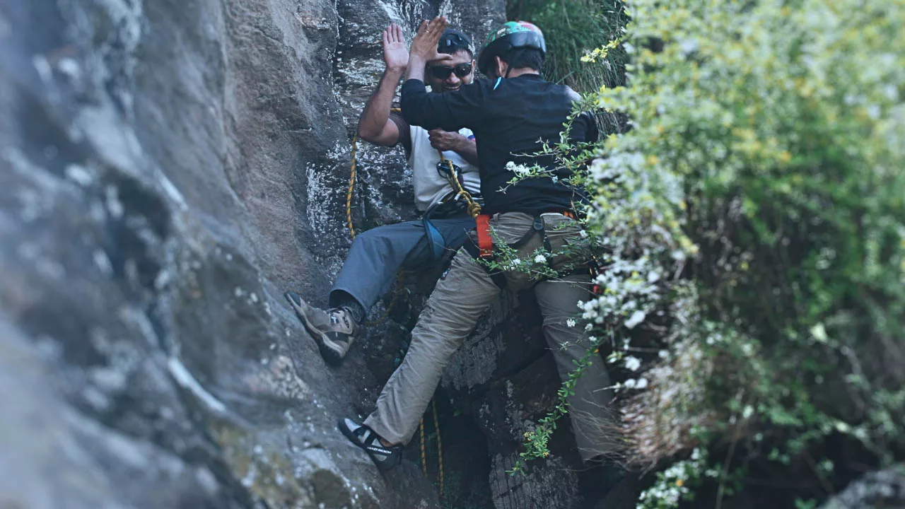 Client and Pankaj Lagwal celebrate after managing risk on a rock face