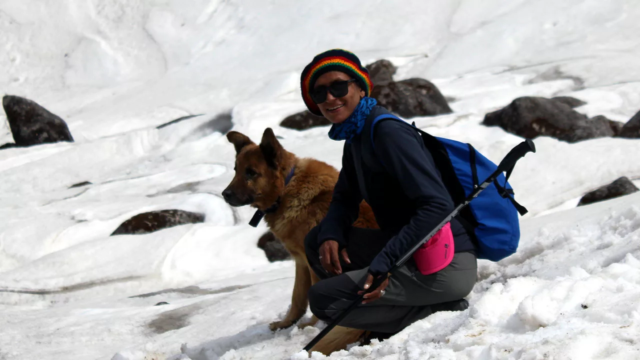 Shashi Lagwal with a dog on mountain slope