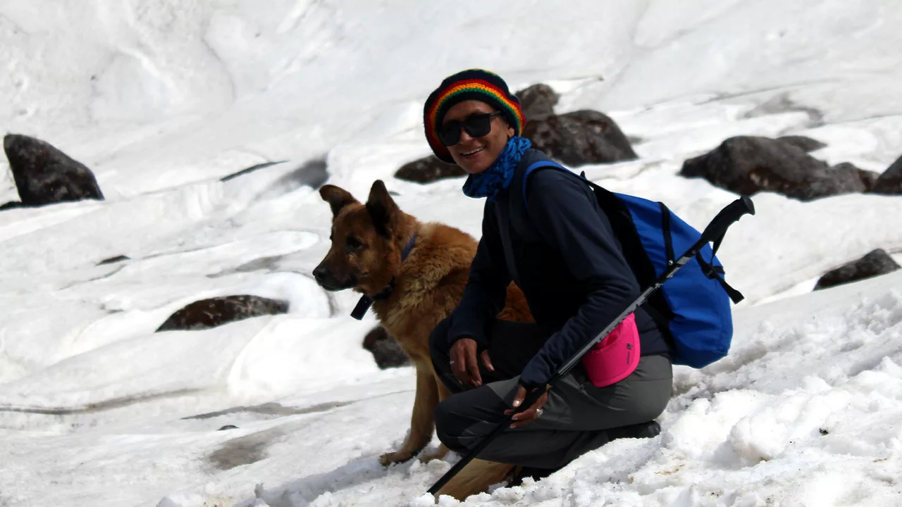 Shashi Lagwal with a dog   on mountain slope 