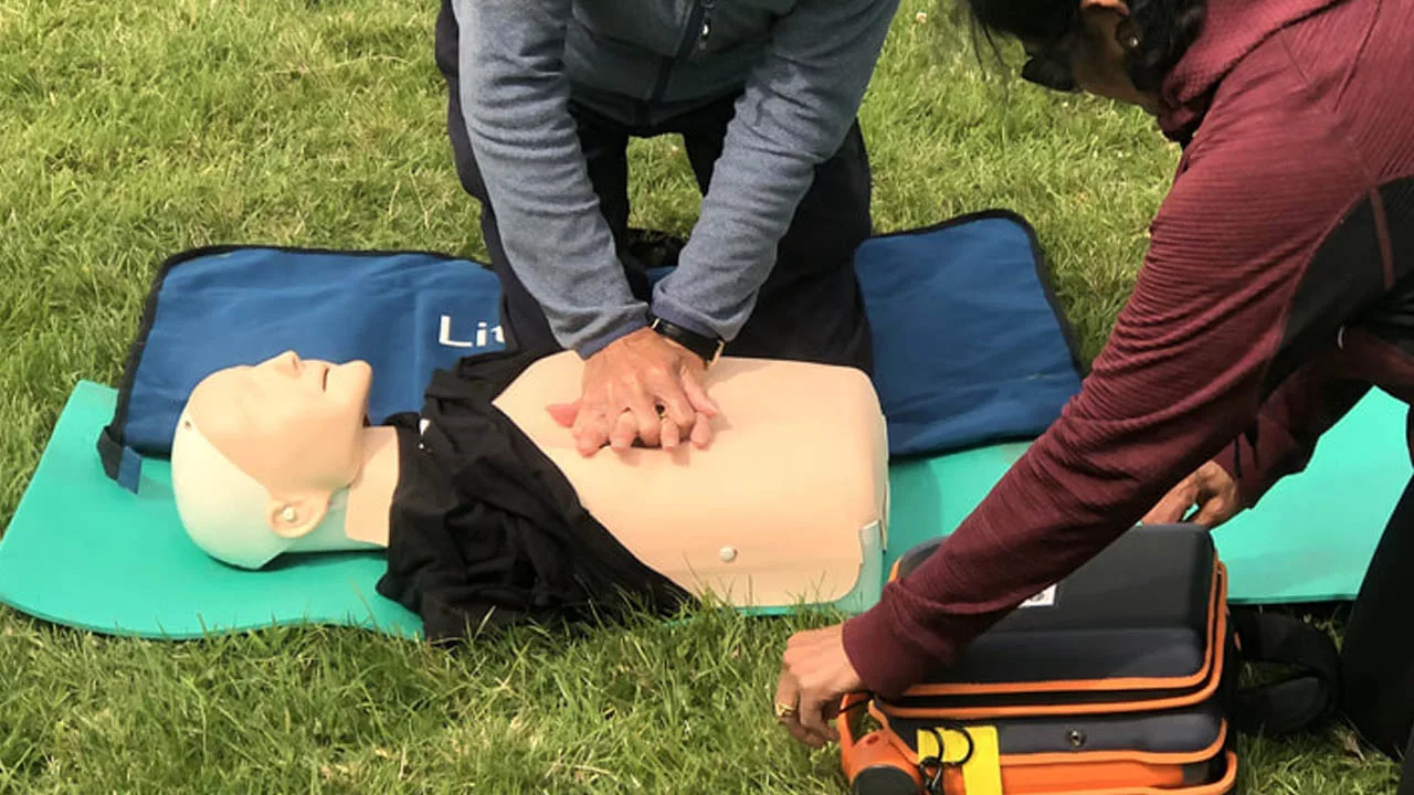 REC First Aid Course Trainee doing CPR on manikins