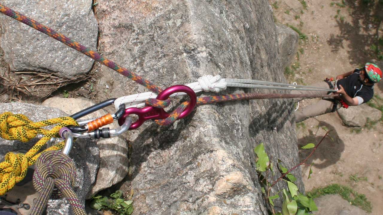 person rappelling and being belayed by figure 8 rope work 