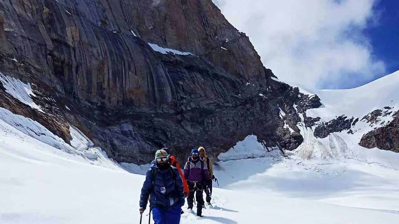 Climbers walking at the base of Cathedral Peak in Lahaul Spiti