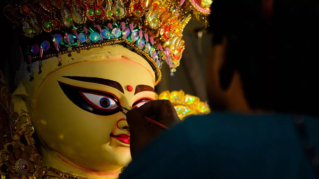person painting Goddess Durga