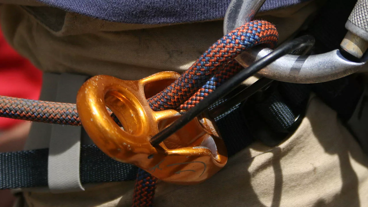 Rope passes through the ATC Belay Device and Carabiner