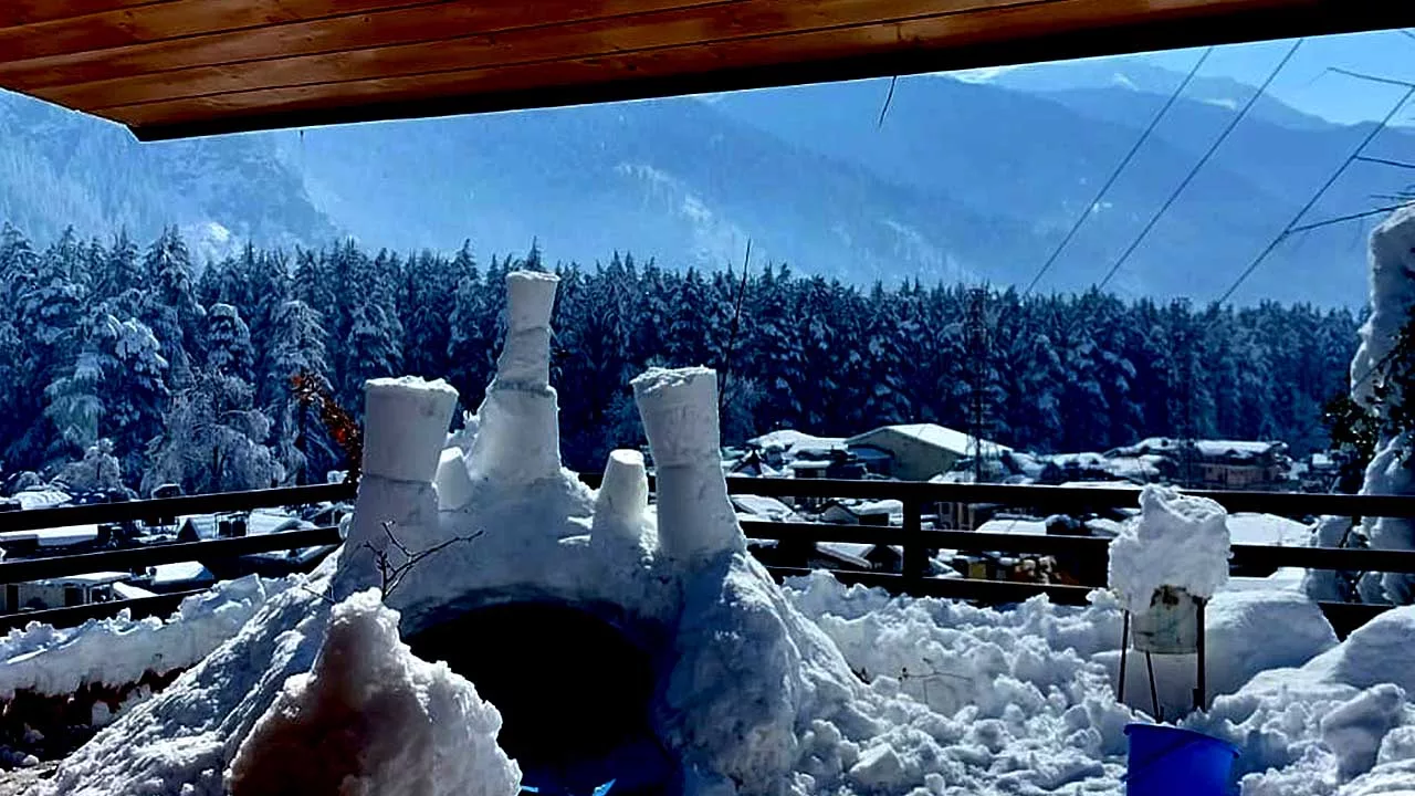 After the Western Disturbances snowfall in Manali, a child builds an igloo on a terrace
