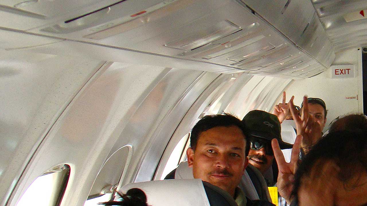 Victory symbol by Makalu Team on the plane returning to India