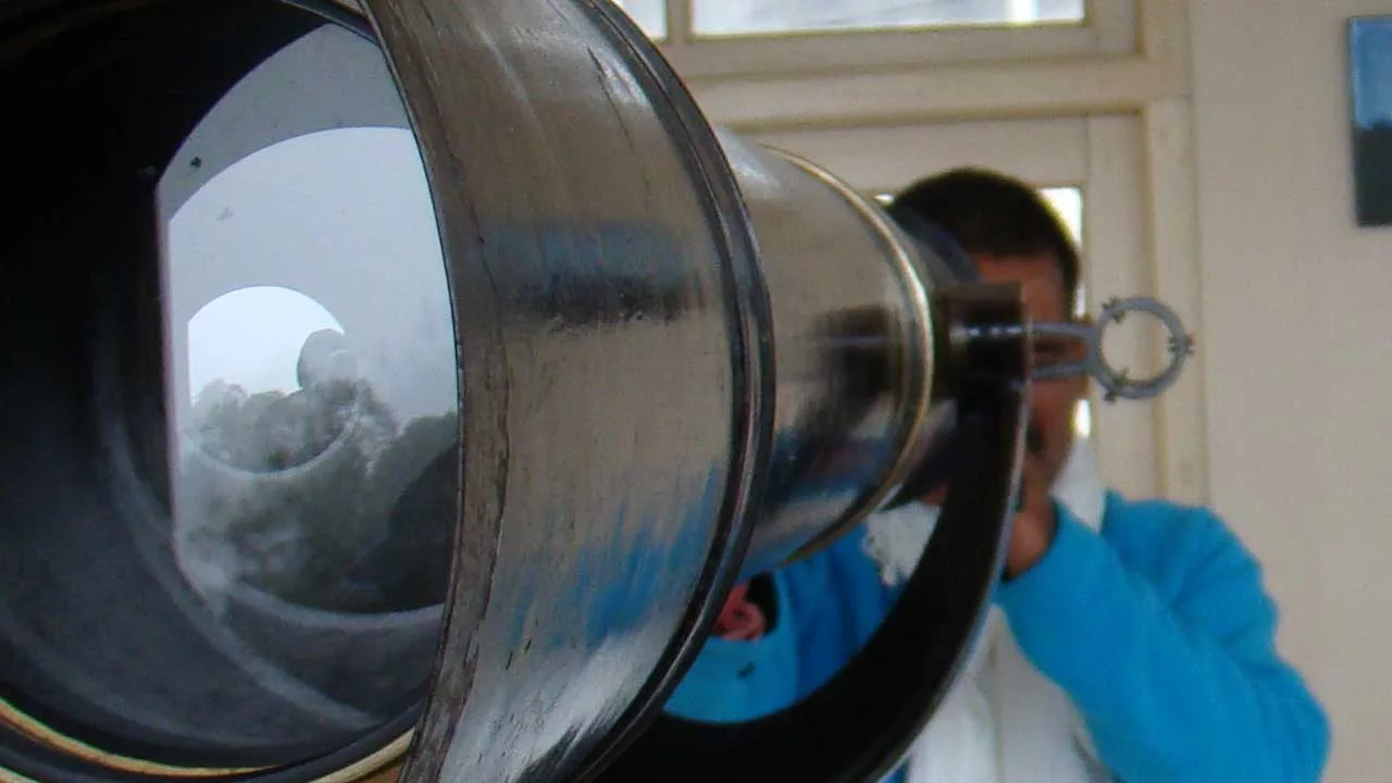 Col Rana looks through a telescope