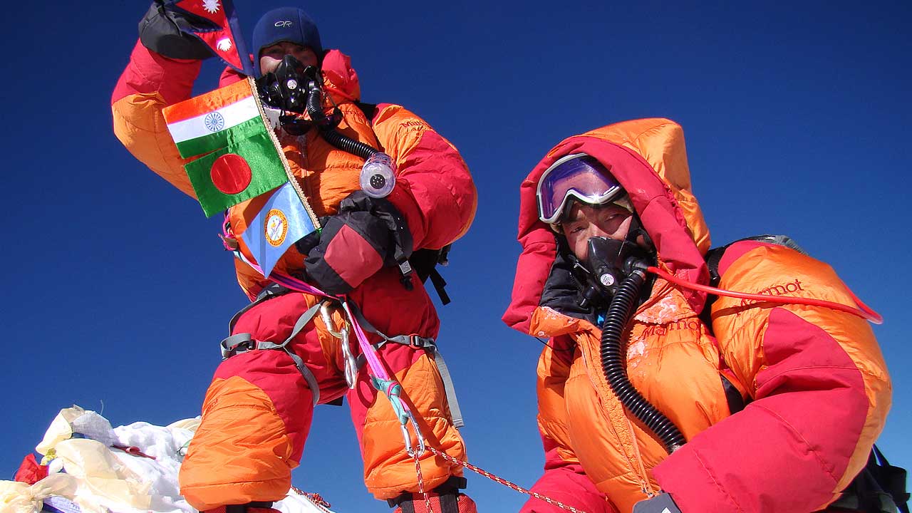 Powell Sharma with flags and Kusang Sherpa on Mt. Makalu summit