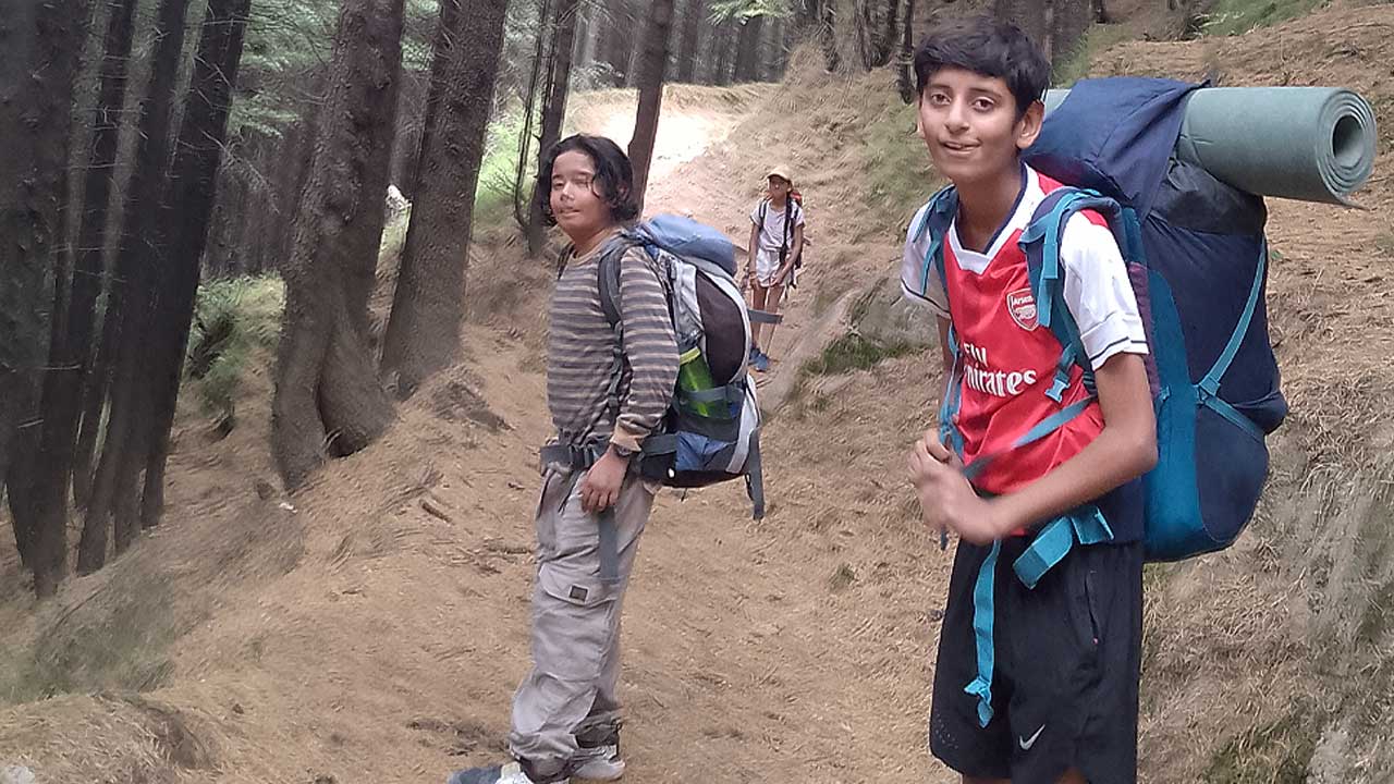 Kids with backpack on trekking trail in Manali