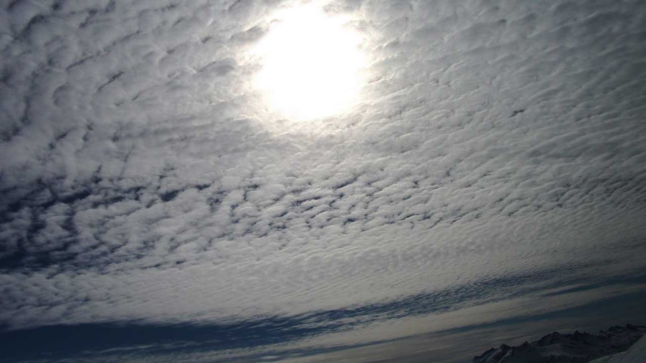 Sun behind cirrus clouds picture from the mountain top