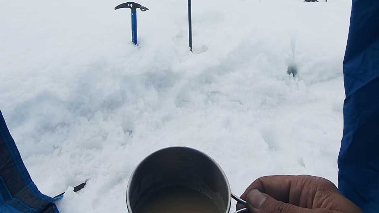 Drinking tea inside tent during winter trekking